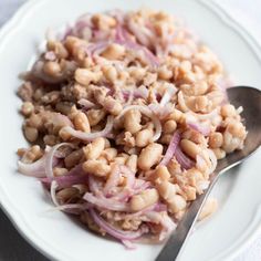 a white plate topped with beans and onions