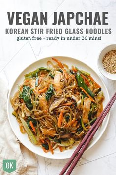 the cover of vegan japanese korean stir fried glass noodles, with chopsticks next to it