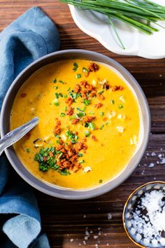 a bowl filled with soup and topped with chopped green onions