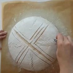 a person is working on a large piece of art that looks like a ball ornament