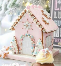 a pink gingerbread house on a table