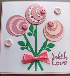 a close up of a card with buttons and flowers