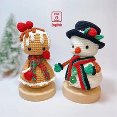 two crocheted snowmen standing next to each other