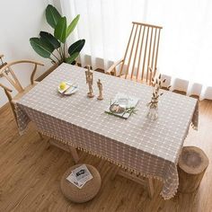 the table is set with two chairs and a potted plant