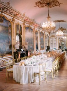 an ornate dining room with chandeliers and tables set for formal dinner or party