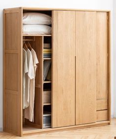 an open wardrobe with clothes hanging on it