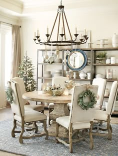 a dining room table and chairs with christmas decorations