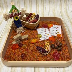 a wooden tray filled with lots of different types of food and decorations on top of it