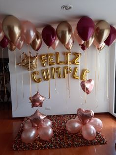 balloons and streamers are on the floor in front of a wall that says hello summer