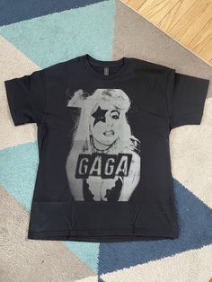 Lady Gaga Tee. GAGA! Shirt is available in black. All sizes from toddlers, kids and youths right up to XXL adults. Lady Gaga T Shirt, Lady Gaga, Gender Neutral, T-shirt, France, T Shirts, T Shirt, Black