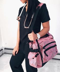 a woman with a stethoscope on holding a pink duffel bag in her right hand