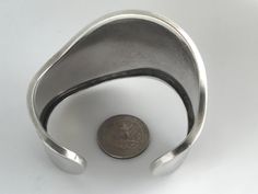 "Big Bold Vintage Taxco Mexico 925 Sterling Silver Wavy Cuff. Clean Bold Modernist Design. Hefty bracelet weighing 57.54 grams. Ready to wear condition. Stamped Maker: 925, Mexico, TS-72 Size: Total inside circumference is 7.0\", Inside diameter across is 2 1/2\", Wrist opening 1.0\", Width is 2 1/4\" front center at widest point. Weight: 57.54 grams Condition: Good vintage condition ready to wear with standard signs of use. See photos. Please review the photos for visual detail and let me know Cheap Metal Cuff Bangle, Cheap Nickel-free Statement Cuff Bracelet, Luxury Modernist Cuff Bracelet For Formal Occasions, Luxury Modernist Sterling Silver Formal Bracelet, Cheap Adjustable Nickel-free Cuff Bracelet, Luxury Silver Modernist Bracelet, Luxury Sterling Silver Statement Cuff Bracelet, Cheap Statement Silver Bangle, Luxury Modernist Sterling Silver Bracelets