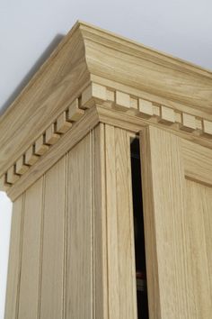 a close up view of the corner of a wooden cabinet