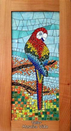 a colorful bird sitting on top of a wooden frame