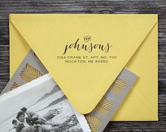 an envelope with some photos on it and the address card is printed in gold foil