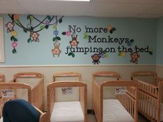 there are many cribs in this nursery room with monkeys painted on the wall