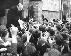 an old black and white photo of a man standing in front of a group of people