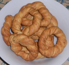 a white plate topped with croissants on top of a table