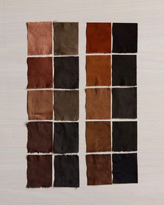 several different shades of brown and black are arranged in squares on a white surface,