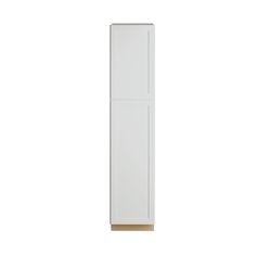 a tall white cabinet sitting on top of a wooden floor