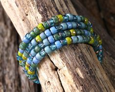 the bracelets are made out of glass beads and wooden sticks, with wood planks in the background