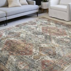 a living room with two couches and a rug on the floor