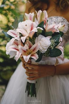 a bride holding a bouquet of flowers in her hands