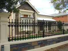 an iron fence is shown in front of a house