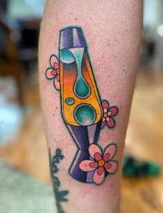 a colorful tattoo on the leg of a person