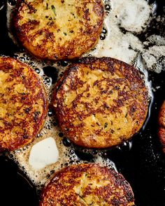 some food is cooking in a frying pan on the stove top with water and oil