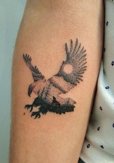 a woman's arm with a bird tattoo on it