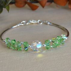 Made with 4mm crystals, 8mm clear swarovski crystal and silver bars Beautiful Beaded Earring, Peridot Crystal, Beaded Earring, Swarovski Crystal Bracelet, Beaded Jewelry Tutorials, Crystal Bangle, Memory Wire Bracelets, Jewellery Ideas, Wire Bracelet