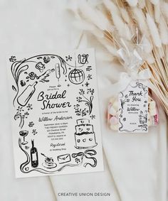 the wedding stationery is displayed next to some dried flowers and pamolite sticks