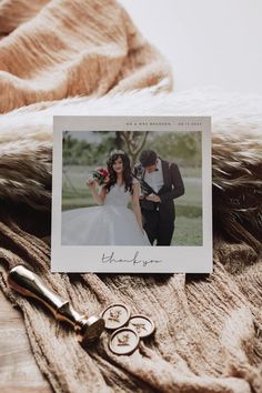 a wedding photo and two pairs of scissors on top of a furnishing blanket