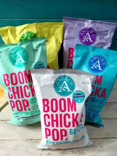 five bags of boom chick pop sitting on top of a wooden table