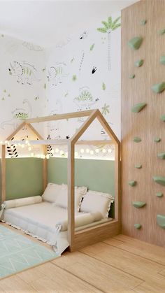 a child's bedroom with green walls and white bedding