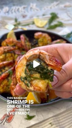 someone is holding up some shrimp in a pan with broccoli and other food