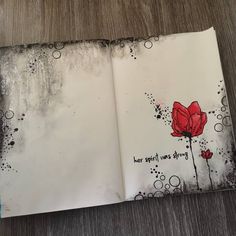 an open book with red flowers on it