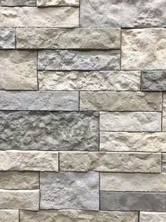 a stone wall that is made out of various types of stones and has been used as a background