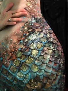 a woman's belly is covered in sequins