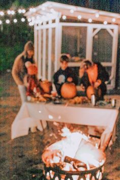 a group of people sitting around a fire pit