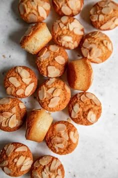 there are many muffins that have been cut in half and placed on the table