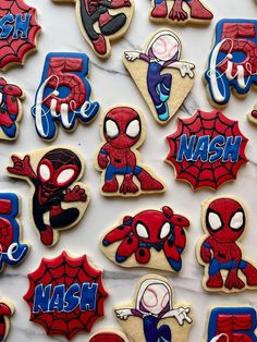 decorated cookies are arranged on a marble countertop with the words, name and spider - man