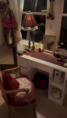 a desk with a chair, mirror and lamp in front of a window that looks out onto the street