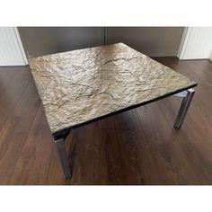 a marble top coffee table with metal legs