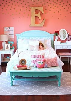 a doll house bedroom with pink walls and white furniture, including a blue bed frame