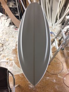 a surfboard sitting on top of a wooden floor