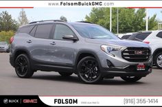 the new 2019 gmc terrain suv is parked in a parking lot with other cars