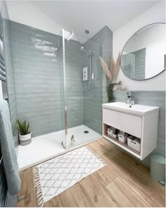 a bathroom with a shower, sink and mirror