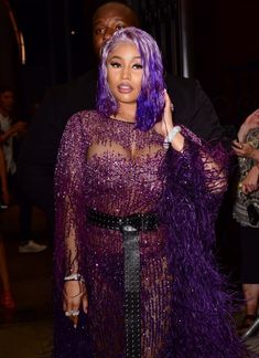 a woman with purple hair wearing a purple dress